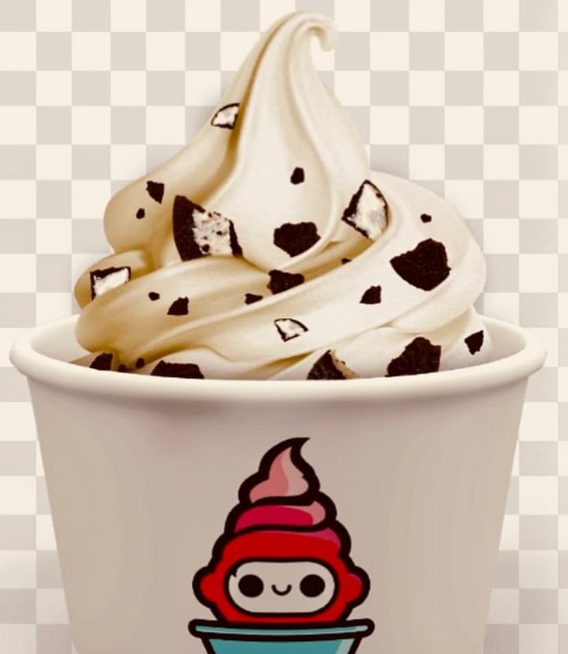 Soft serve dispensing into a cup inside the FroYoRobo machine