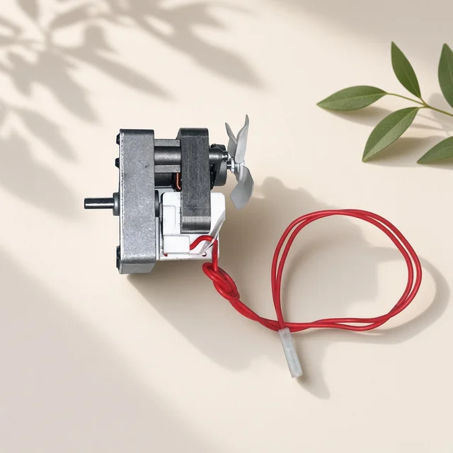Illustration of a small silver pellet grill auger gear motor with red lead wire